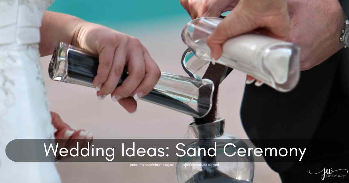 Bride, groom and anothers hand pouring black, grey and white sand into a glass vase at a wedding. Text reads: Wedding Ideas: Sand Ceremony.