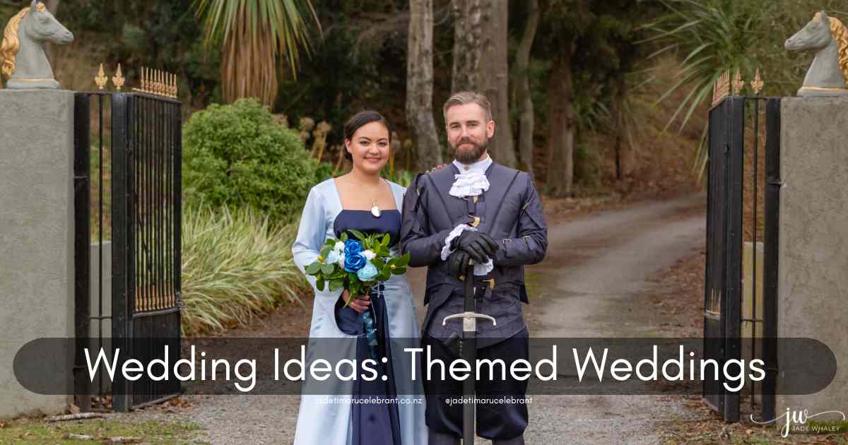A wedding couple dressed in medieval costumes, standing on a gravel road with a large fence with horses heads behind them. The bride is wearing blue, an elegant regal dress, and the groom has on a jacket and pants with a sword. The words say, 