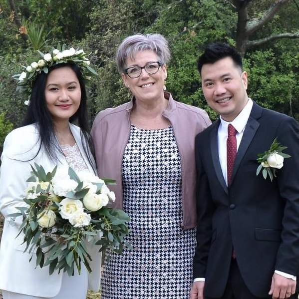Bride and groom smiling with Jade Whaley wedding celebrant after eloping at Timaru Botanical Gardens.