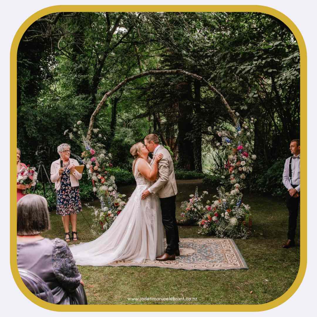 They are just married at Stonebridge weddings and events in Geraldine. Jade Whaley, the Marriage celebrant, and a couple at the arch. Photo by Joseph O'Sullivan Photography. 